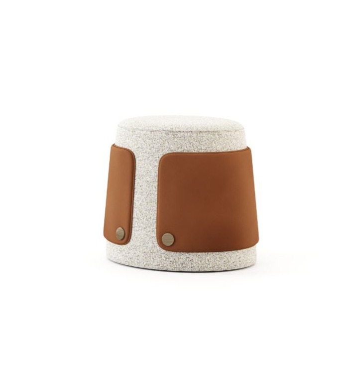 The Dolomites Stool is shown as a cylindrical piece with an organic, softly rounded form upholstered in textured light fabric, featuring smooth brown leather side panels secured with two round metallic fasteners near the base.