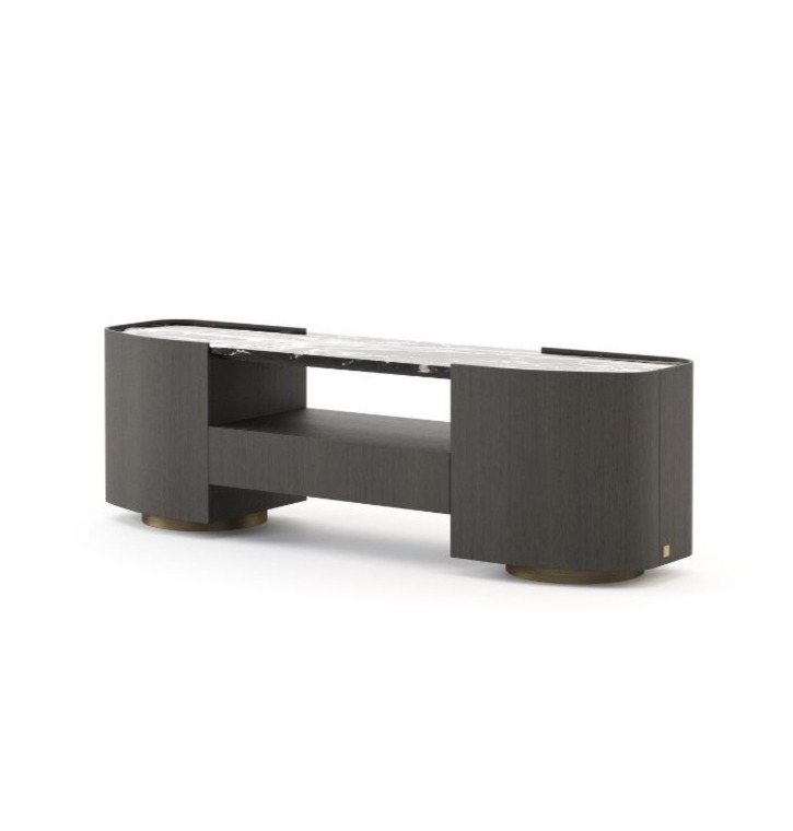 The Stone low console table is presented as a multimedia unit featuring a dark wood frame, rounded side compartments, a stone top and an open central shelf, supported by circular metal feet, in a contemporary interior setting.