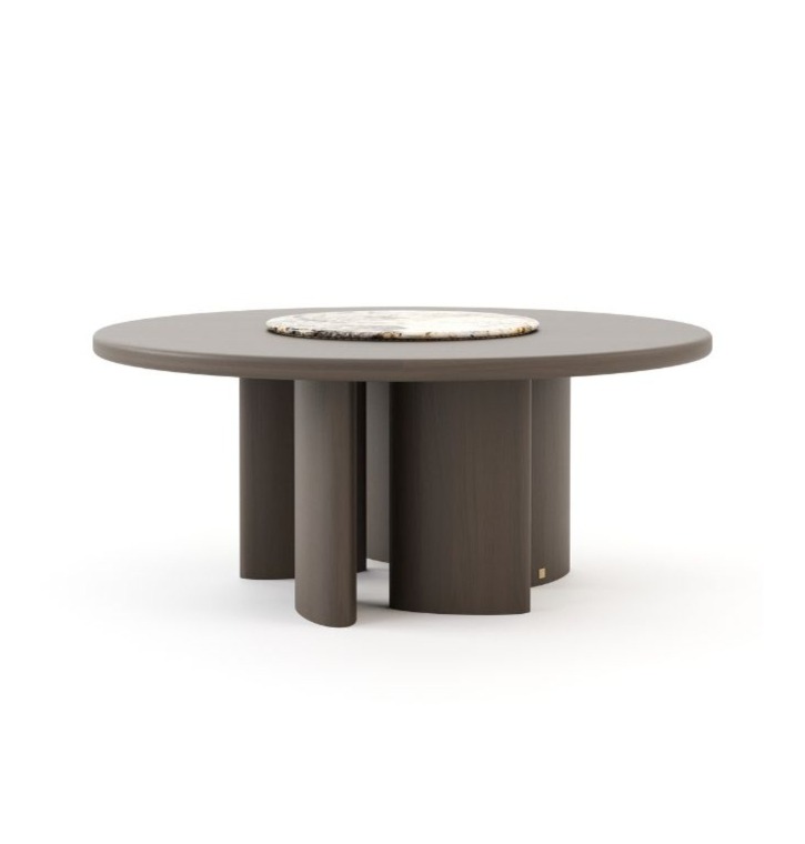 The Dolomites Round Dining Table is shown as a dark wooden round table with a smooth top and a light marble center inlay, supported by multiple cylindrical legs arranged in a circular formation, highlighting its sculptural and contemporary design.