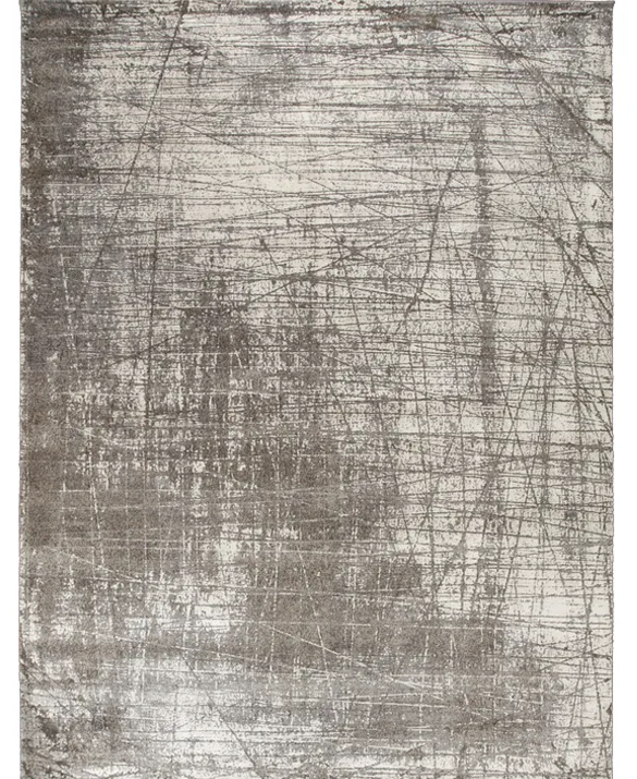 Foto di un tappeto dal disegno astratto nei toni del grigio