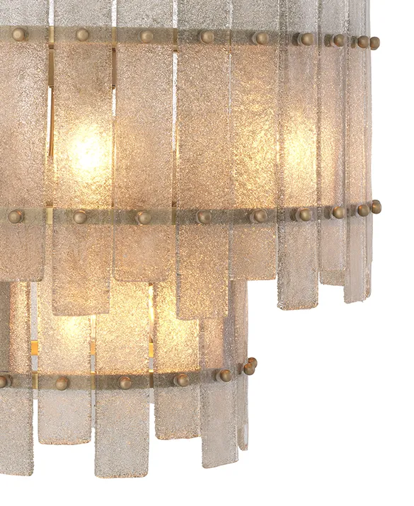 Chandelier Caprera - Chandelier Caprera presents a sophisticated contemporary twist on a classic design. Finished in antique brass, it features 10 lights in a tapered, two-tiered design. The drops are made of hand-blown glass with a roughened backside, which produces a startling effect when the lamp is lit.