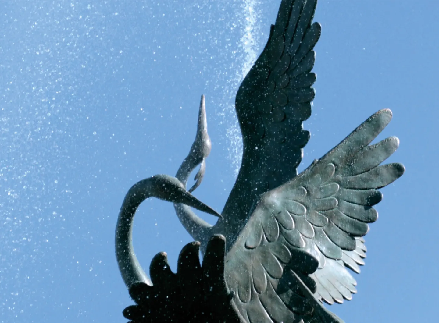 Detail of bronze fountain depicting herons in flight