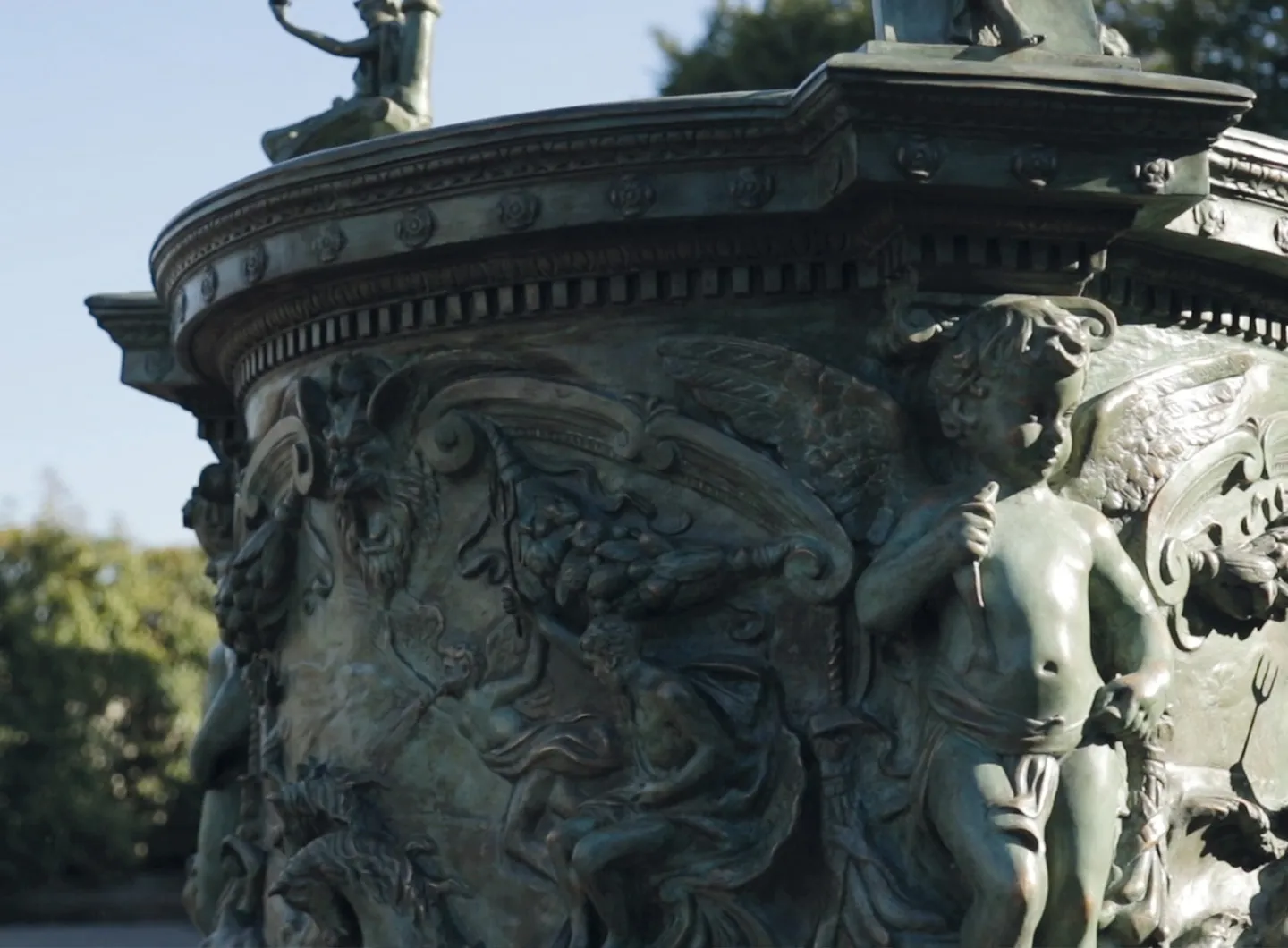 Detail of bronze well with relief decoration of putti and floral festoons