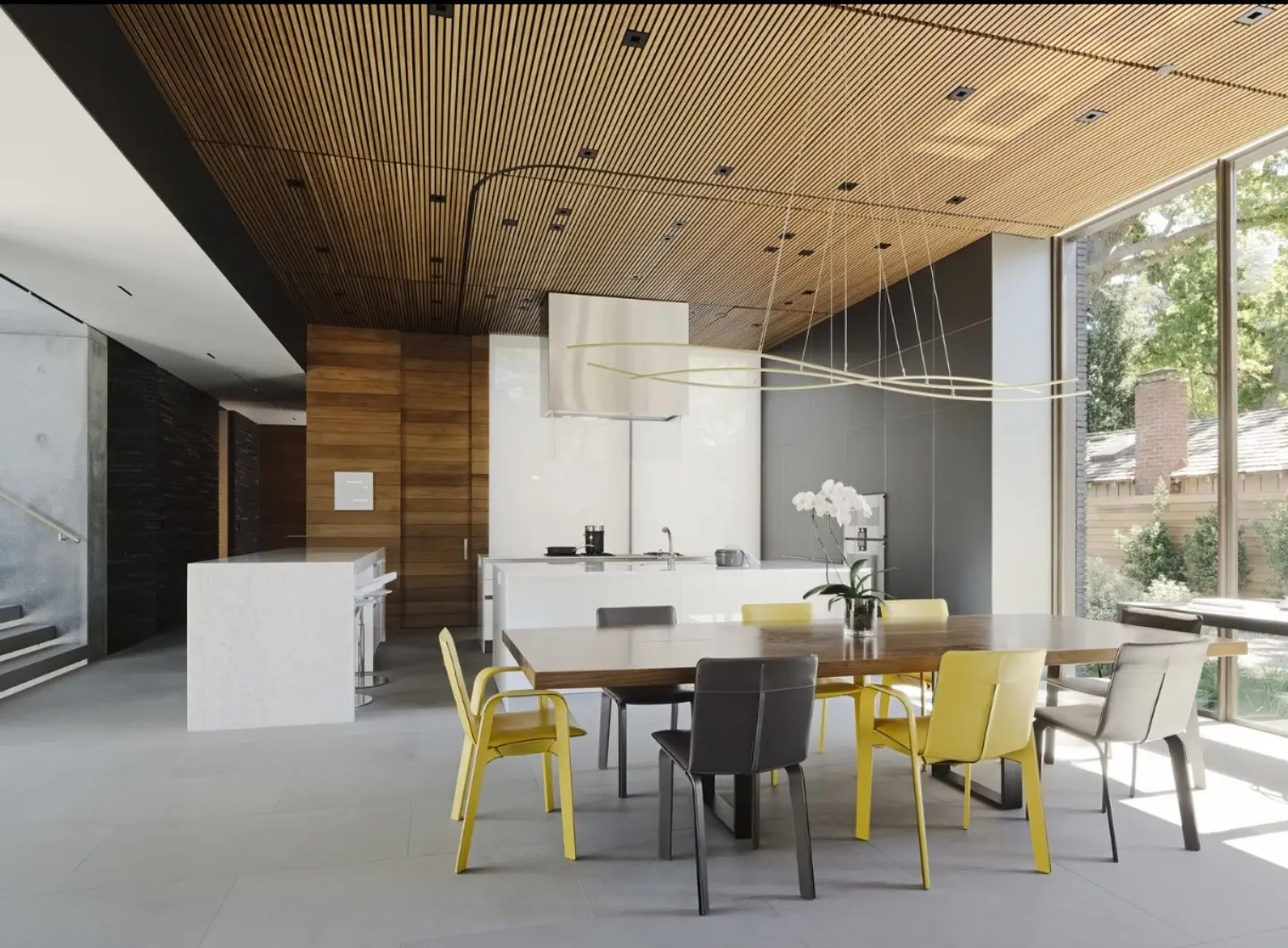 JH_hermes_sellier_chairs_in_jaune_and_etaine_surround_the_custom_dining_table.jpg