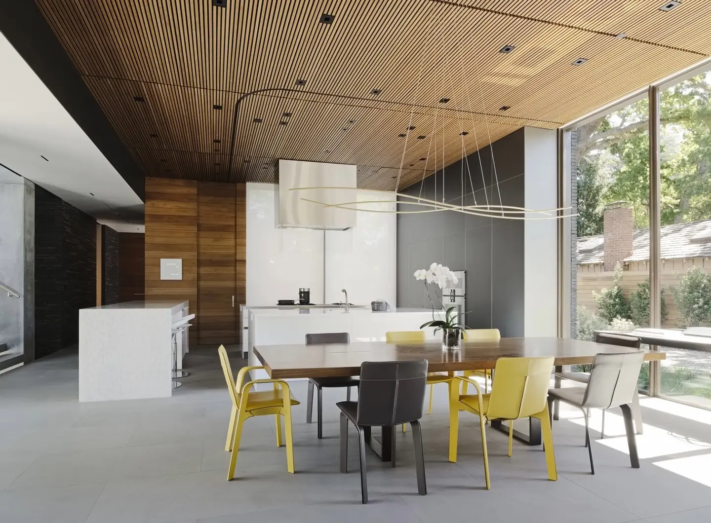 JH_hermes_sellier_chairs_in_jaune_and_etaine_surround_the_custom_dining_table.jpg