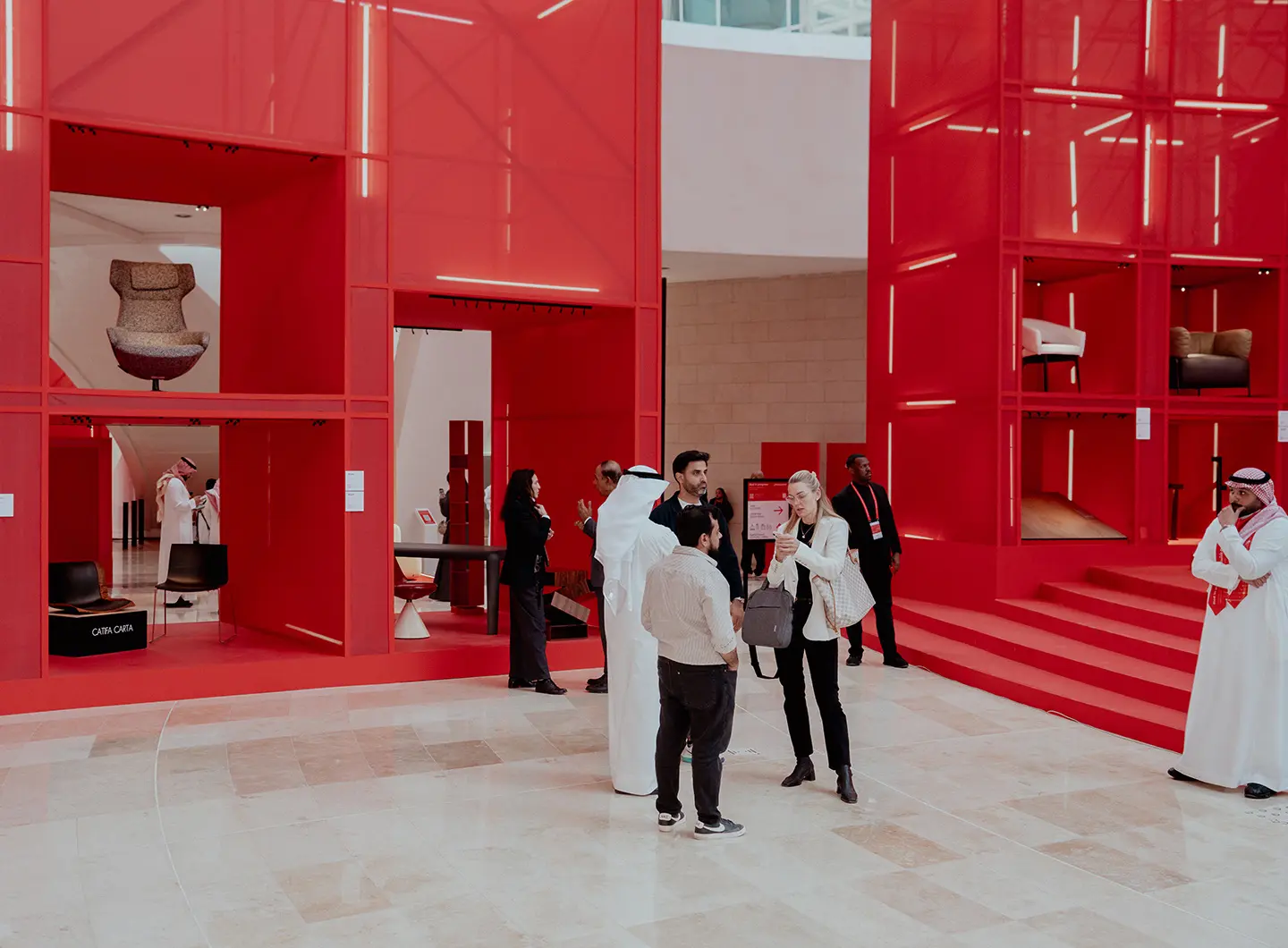 Red in progress, installation Giò Forma, with visitors viewing the products