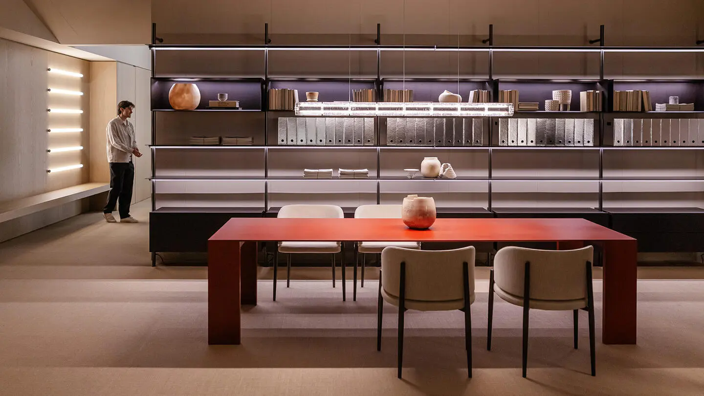 Stand with dining table and armchairs, modular bookcase system with storage units and shelves