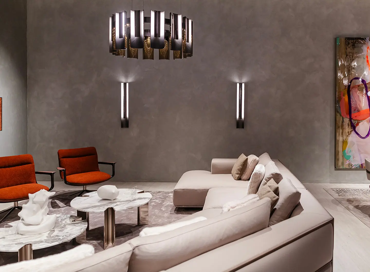 Living room with beige corner sofa, armchairs and marble and metal coffee tables