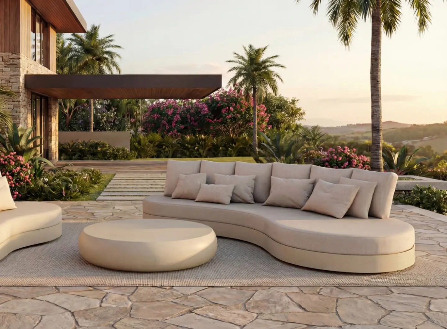 HARMONY Sofa by GANSK in a landscaped garden terrace, a curved low outdoor sofa with plush cushions and a rounded coffee table.