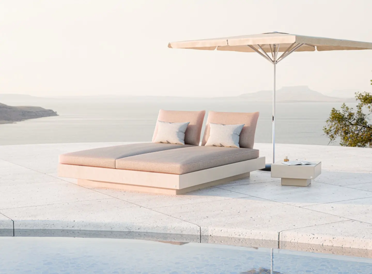 NORDIC Double Sun Bed by GANSK beside a pool with sea views, featuring two cushioned loungers under a large parasol and a small side table.