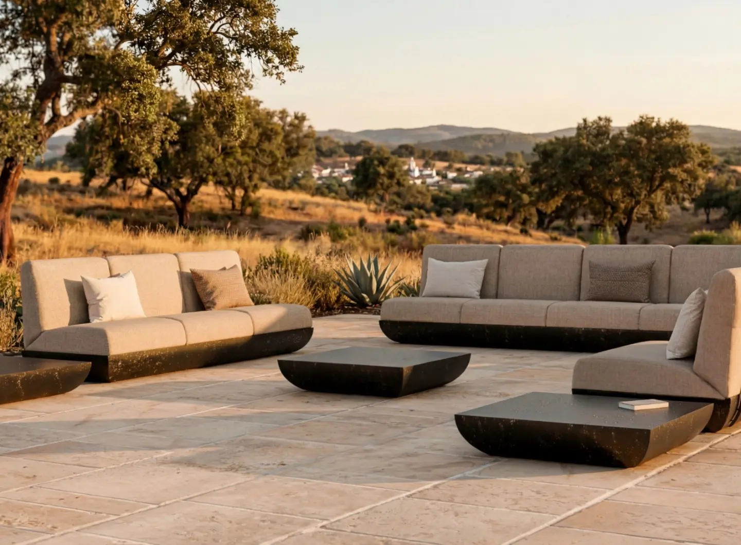 VITORIA modular outdoor seating by GANSK on a countryside terrace, with multiple sofa configurations and sculptural low coffee tables.
