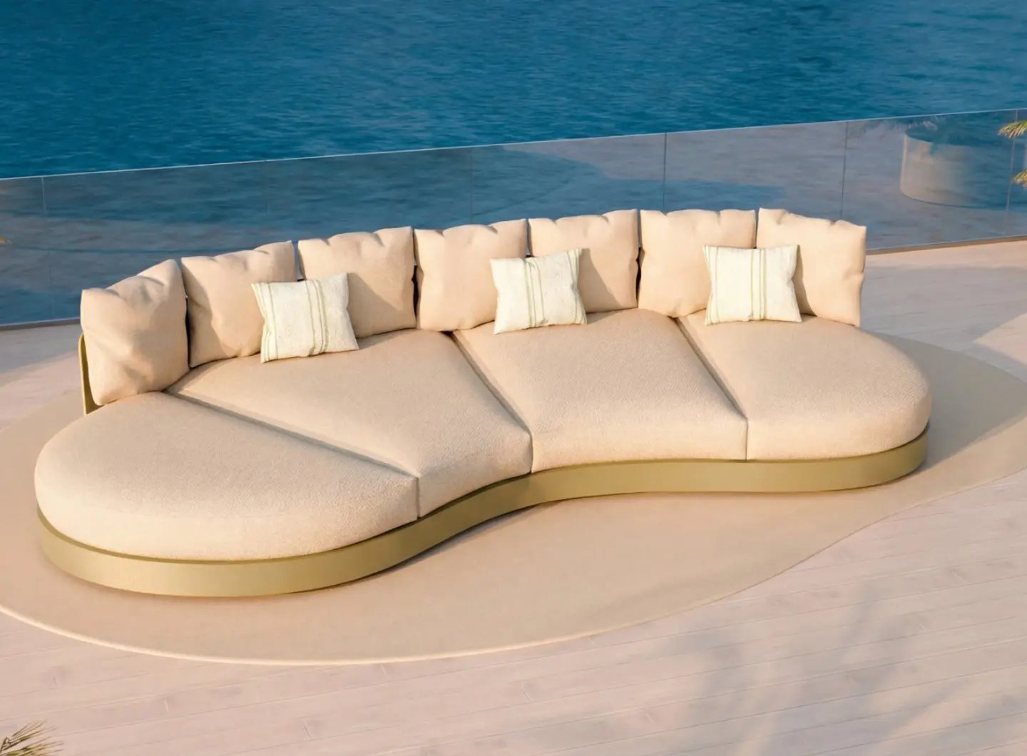 HARMONY Sofa by GANSK, a curved low outdoor lounge with oversized cushions on a sea-view terrace.