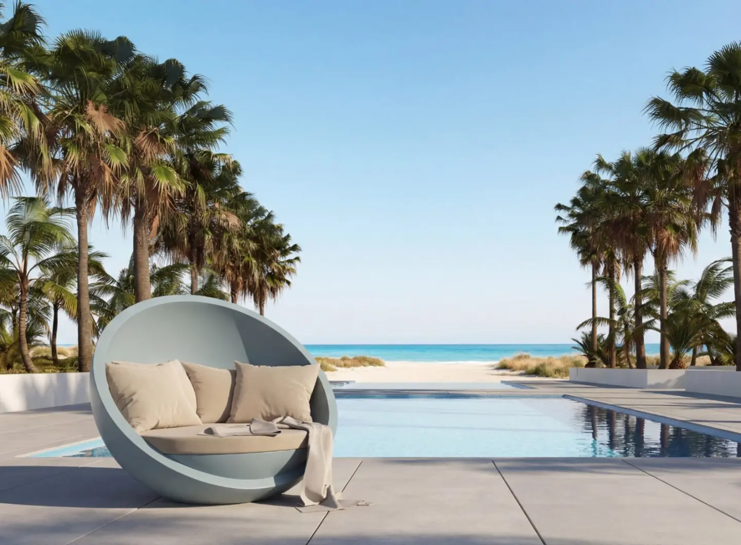 BOLA Sofa by GANSK on a poolside terrace with palm trees and a direct view to the beach and sea.
