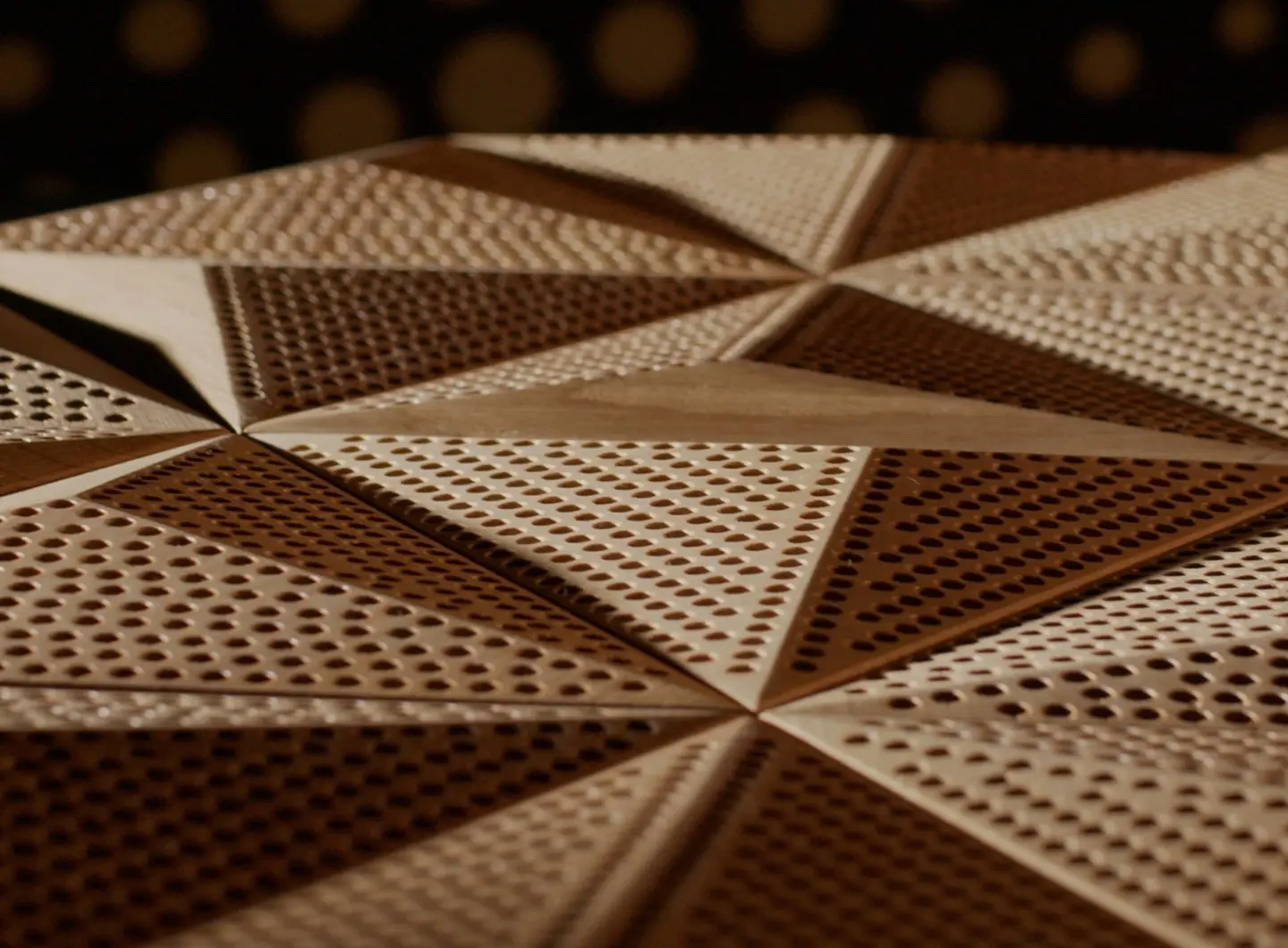 Macro close-up of acoustic perforation in 3D oak wood panels (Hexagon pattern), showcasing precise holes, milled edges, and natural oak grain.