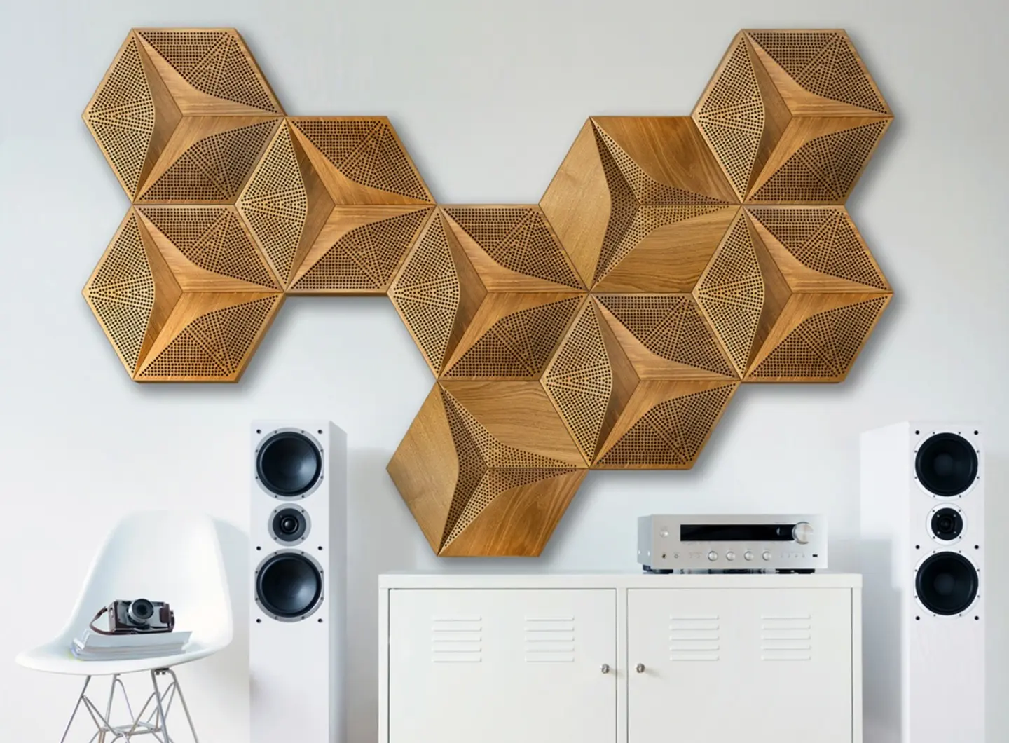Modern Hi-Fi listening room featuring 3D oak acoustic panels in Hexagon pattern on a white wall, with white floorstanding speakers and audio amplifier.