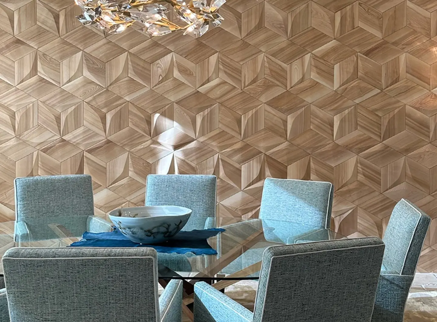 Modern dining room featuring a 3D oak wood wall in a Hexagon Cube diamond pattern, with a glass table and blue chairs.