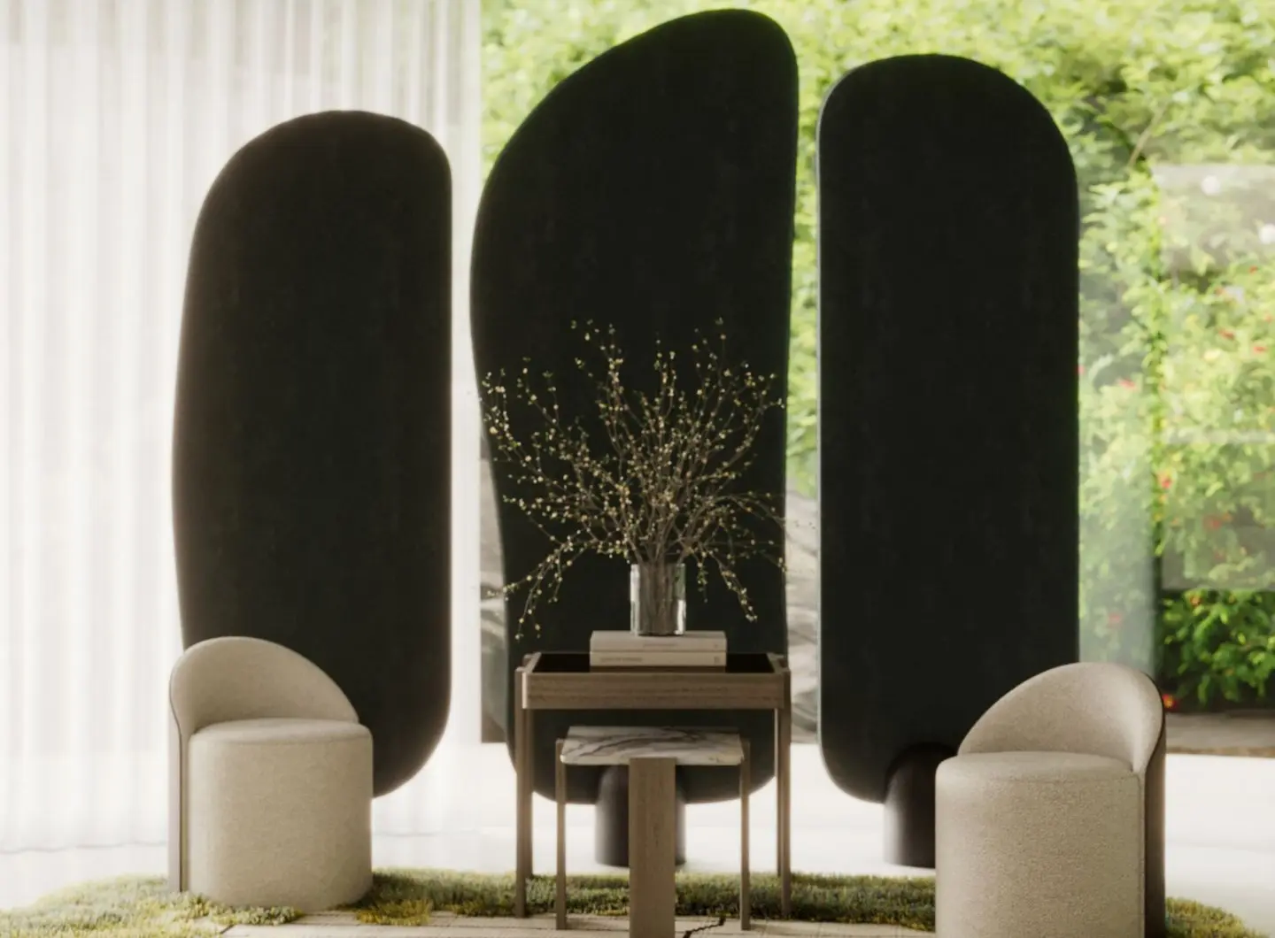 The Stone Screen appears as three large dark sculptural panels with smooth, organic curves, positioned behind two rounded beige chairs and a wooden table in a softly lit room with sheer curtains and greenery visible outdoors.