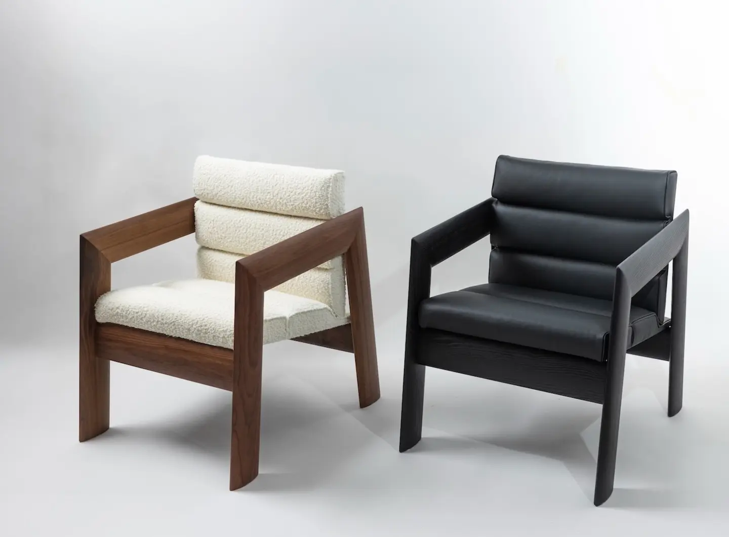 Walnut lounge chair with white fabric upholstery & blackend ash lounge chair with black leather