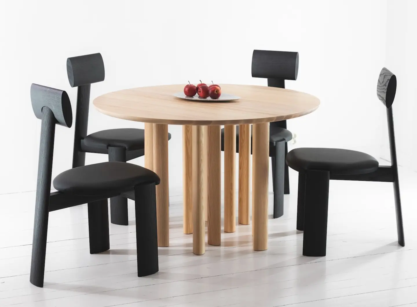Round dining table in ash & chairs in blackened ash and leather
