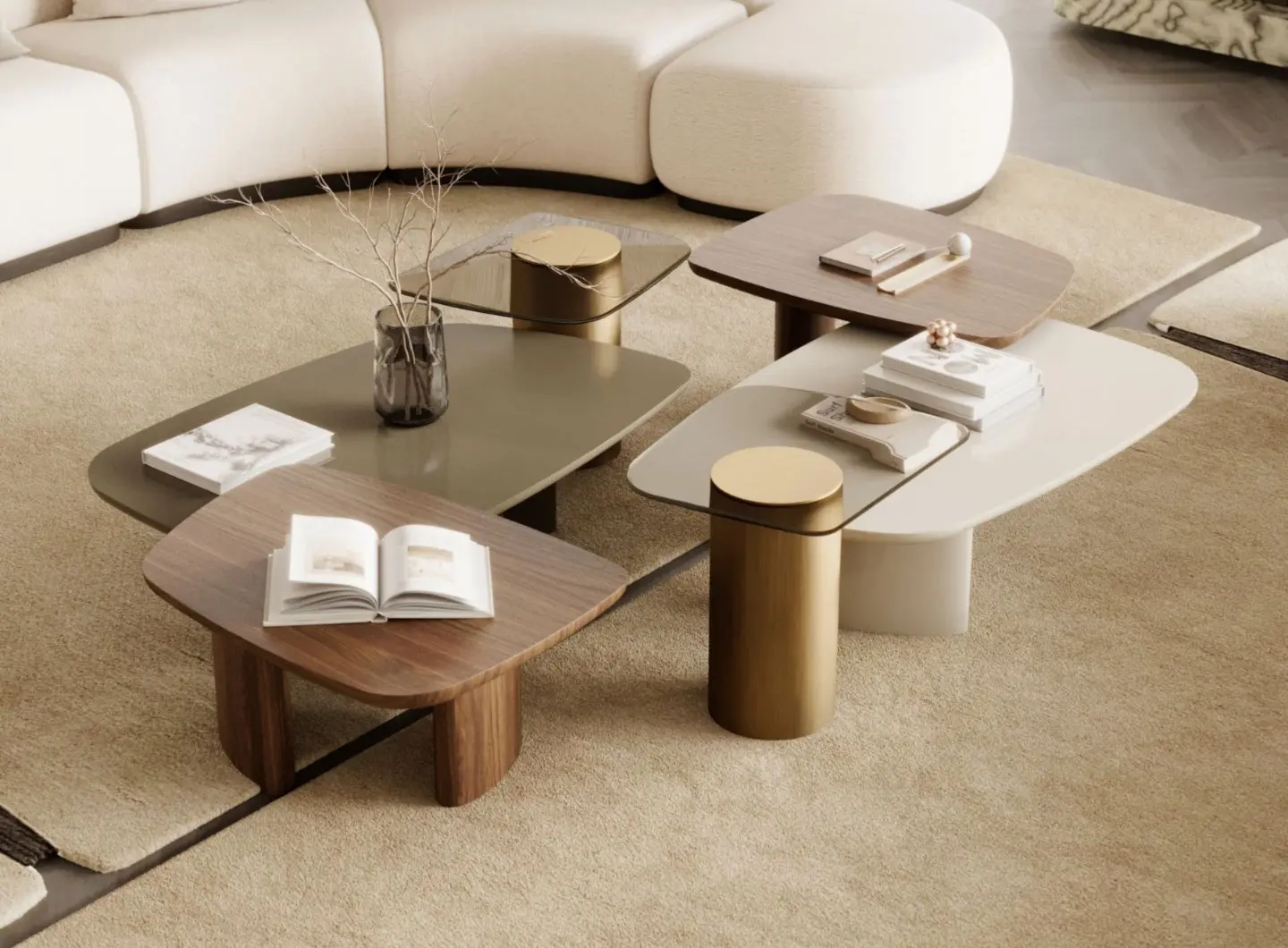 The Dolomites Coffee Table is shown as a group of four tables arranged on a beige rug, featuring mixed surfaces in light wood, glossy olive green, pale beige, and dark wood, supported by cylindrical or block‑style legs that include metallic brass elements, with decorative objects placed on top.
