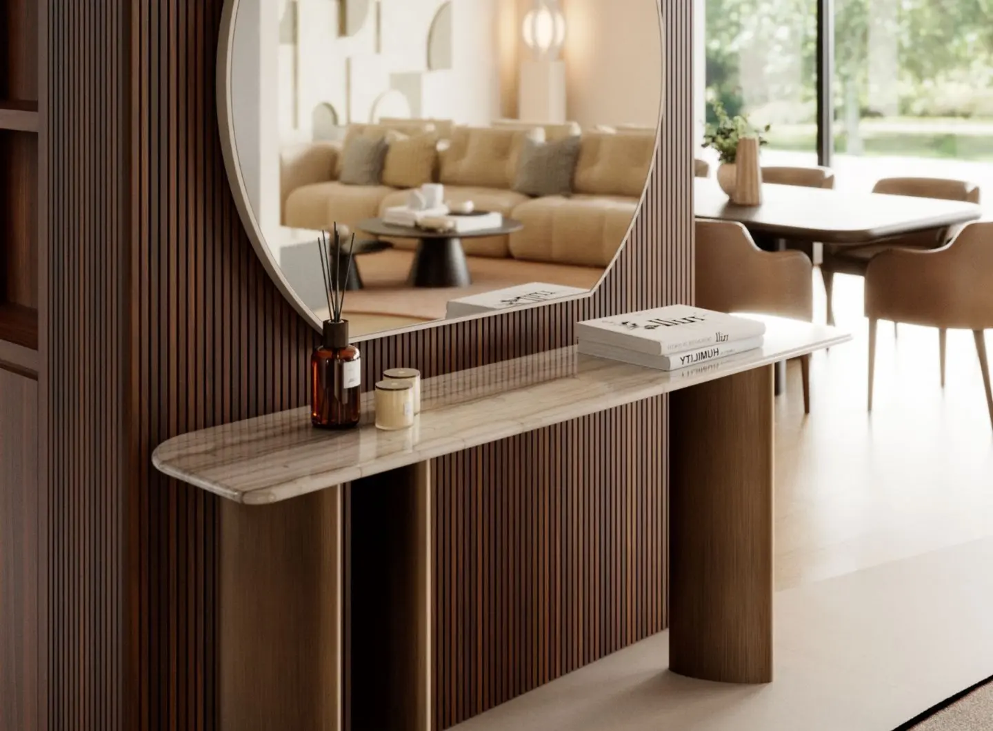 The Dolomites Console is shown with a marble top featuring natural veining, supported by three dark cylindrical legs, placed against a wall with vertical wooden slats and styled with candles, a diffuser, and books beneath a large round mirror.