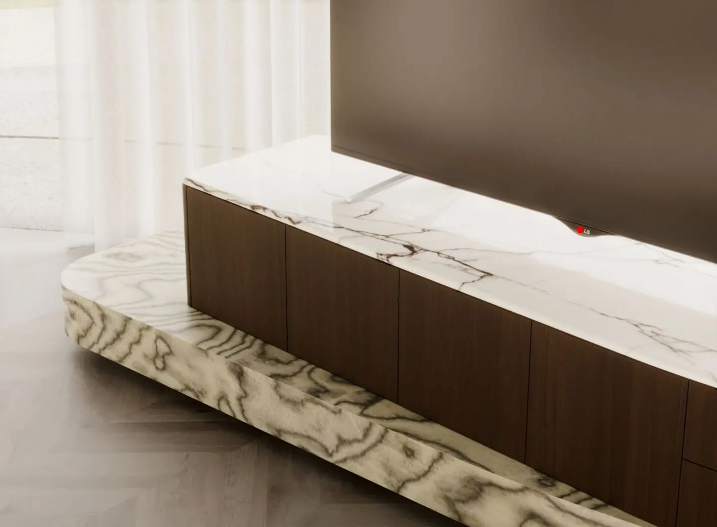 The Stone TV Cabinet supports a large television on a travertine top with white and grey veining, paired with a wooden storage section and a stone‑inspired base, placed in a bright living space with sheer curtains and a light herringbone floor.