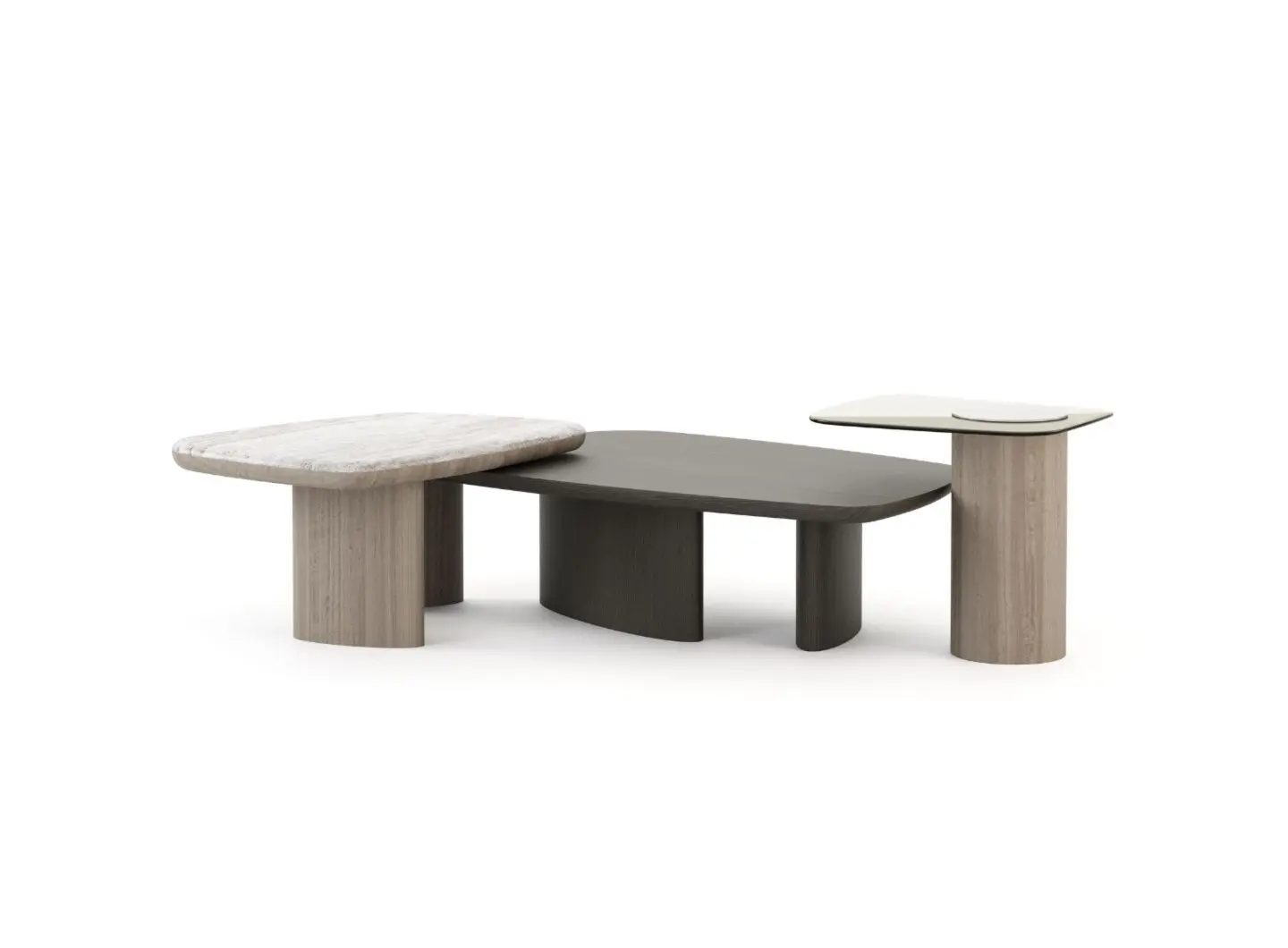 The Dolomites Coffee Table appears as three interconnected tables with rounded rectangular tops in textured stone‑like, dark wood, and smooth pale finishes, supported by cylindrical wooden bases that incorporate brass details in a staggered sculptural arrangement.