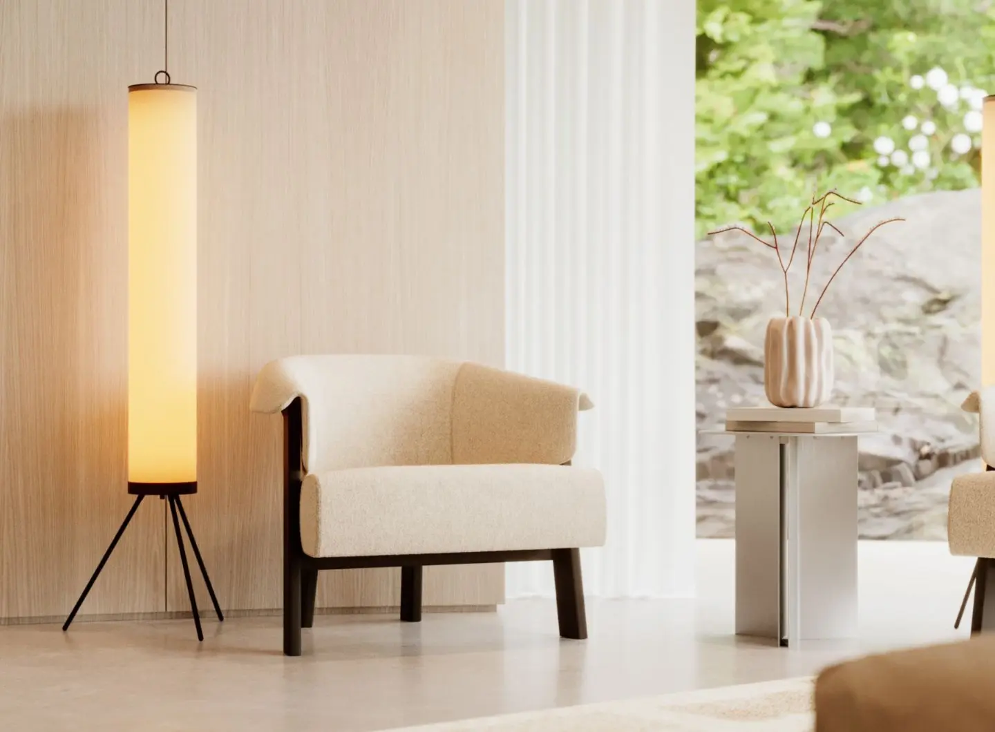 The Steel Side Table is placed beside a beige armchair and a warm floor lamp as a round steel table with a pale metallic base and simple top supporting a ceramic vase with dried branches, bringing a serene, understated elegance to the softly lit interior.