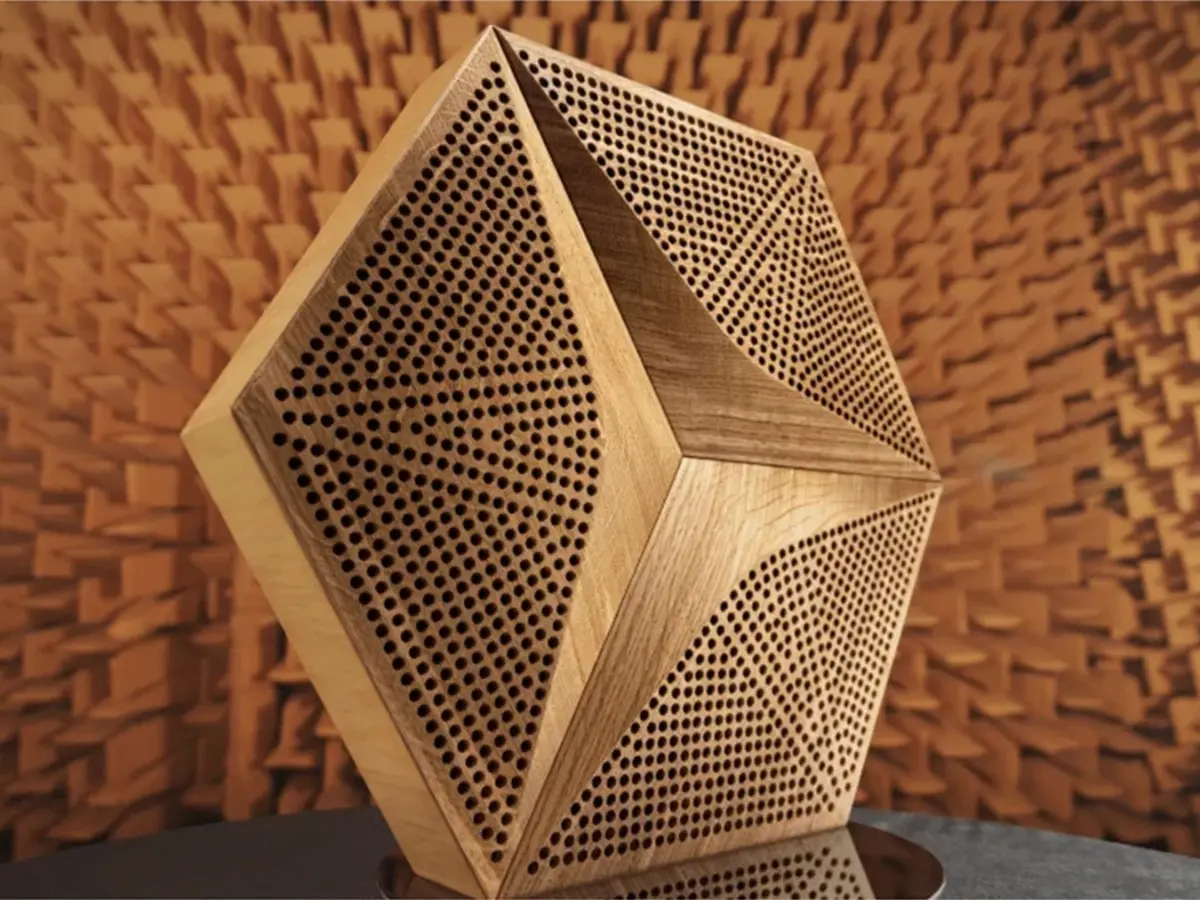 Modern luxury living room featuring a dark grey wall with an installation of acoustic hexagonal oak wood panels, large sofa and TV.