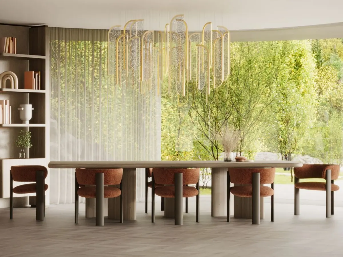 The Dolomites Chair appears as a set of rust‑colored upholstered dining chairs arranged around a large wooden table, each chair featuring a rounded cushioned seat and a curved backrest supported by tall wooden legs, placed in a bright dining room with floor‑to‑ceiling windows and a sculptural chandelier.