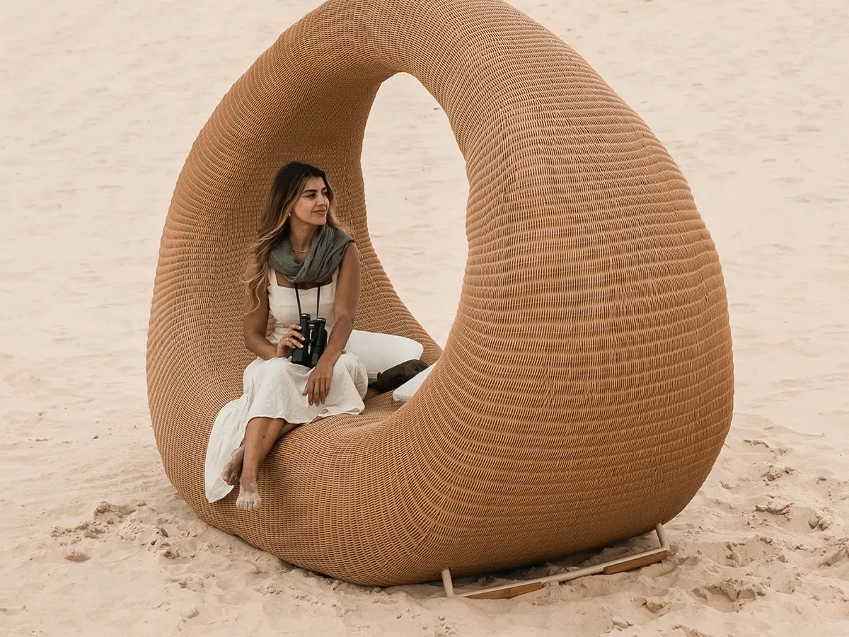 Chaise longue made of synthetic wicker with a shape similar to that of a handbag.