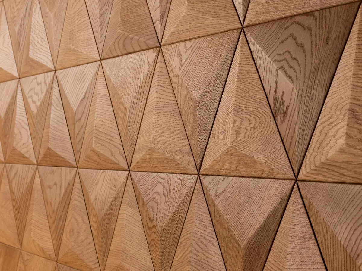 Modern 3D wood wall panels featuring a geometric pyramid and triangle pattern, creating a rhythmic wooden mosaic.