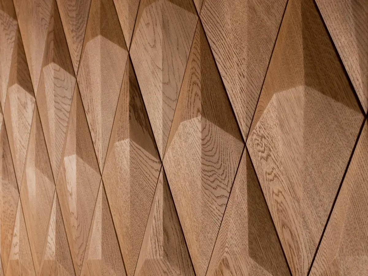 Perspective view of 3D oak wood wall panels in a diamond pattern, highlighting natural wood grain and geometric depth.