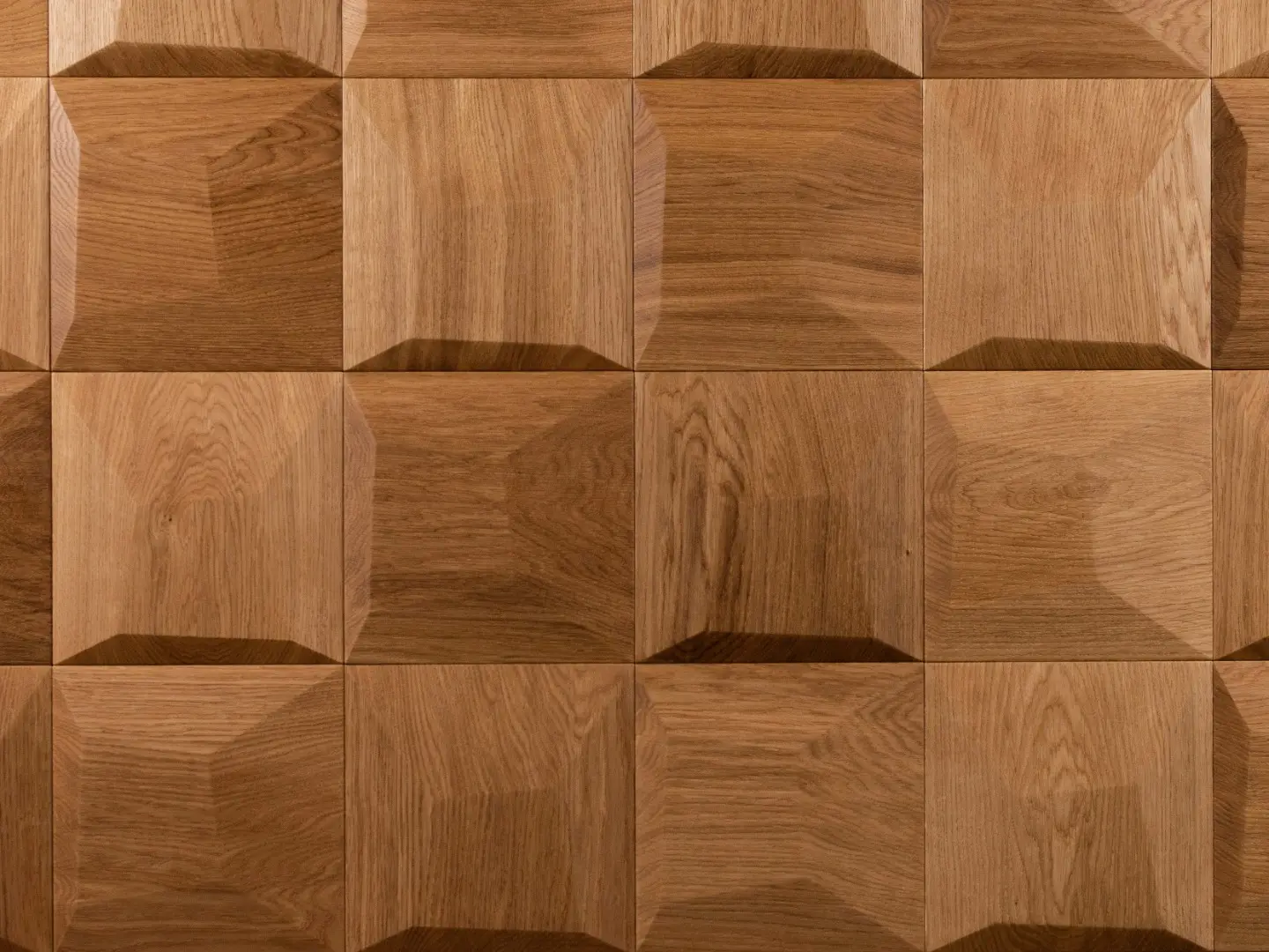 Close-up of 3D oak wood wall panels in a natural finish, featuring a pillow pattern and clear wood grain texture.