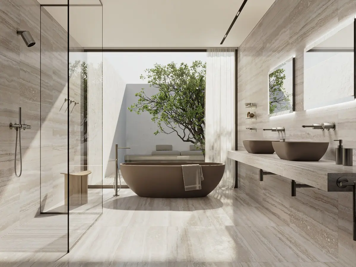 The 316 stainless steel of GENT's faucets and accessories blends seamlessly with the silver travertine of the wall tiles