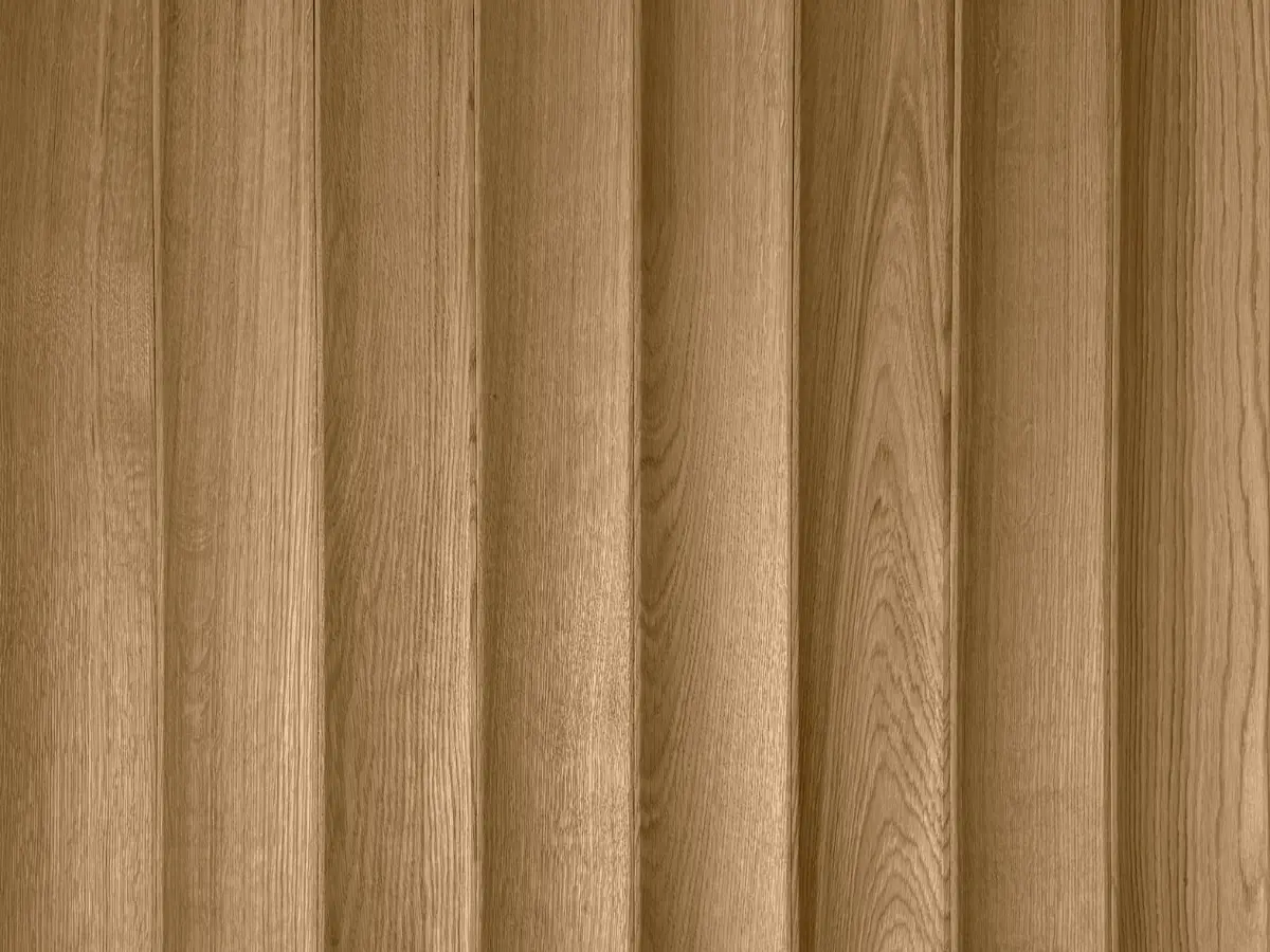 Close-up of natural 3D oak wood slats in a vertical arrangement, showcasing rhythmic texture and wood grain.