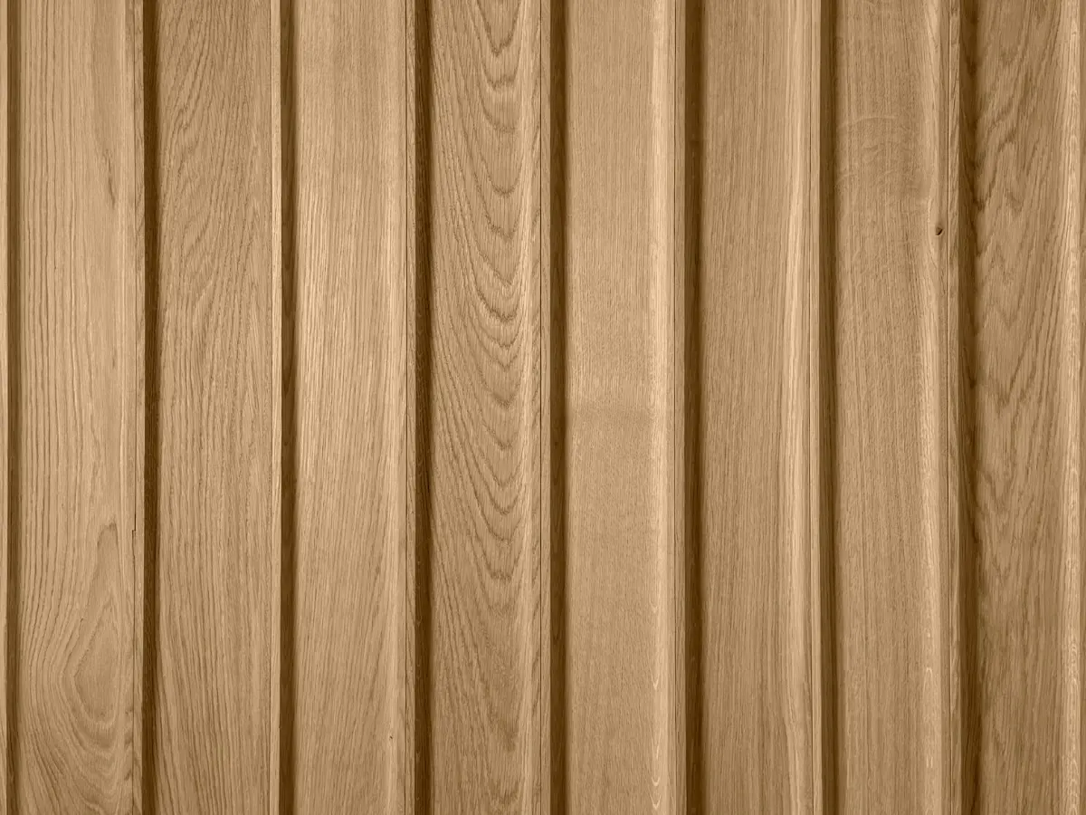 Sample of natural 3D oak wood slats in a vertical arrangement, showcasing the rhythmic texture of vertical planks.