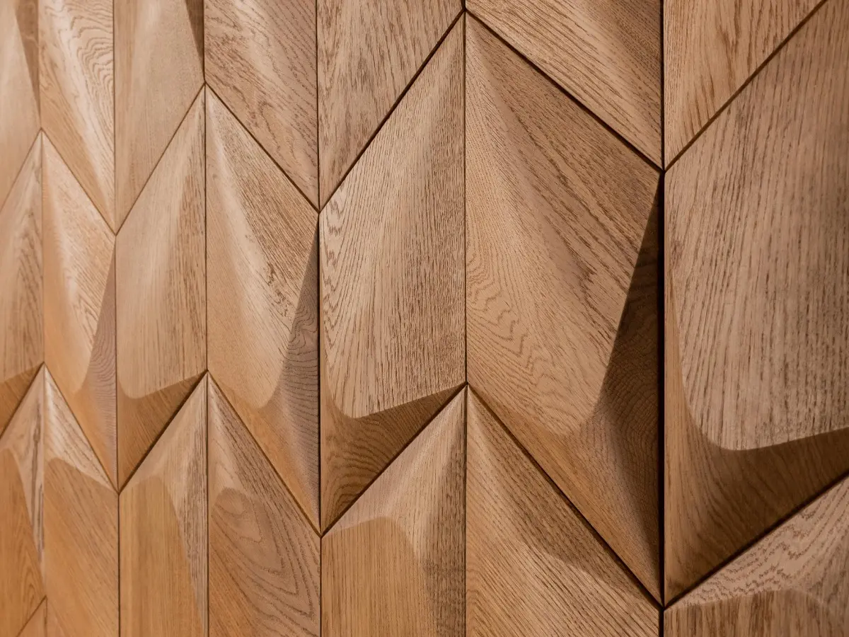 Detailed close-up of 3D oak wood wall panels in a diamond pattern, showcasing natural grain texture and geometric depth.