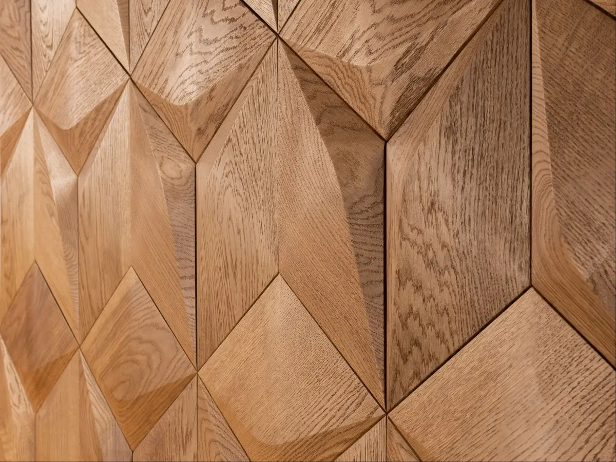 Perspective close-up of 3D oak wood wall panels in a diamond pattern, showcasing natural wood grain and precise geometric edges.
