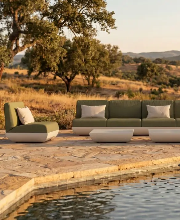 VITORIA Sofa by GANSK in an outdoor setting, a modular three-seat sofa with two lounge modules and low coffee tables by a pool.