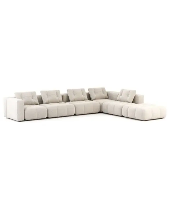 The Antónia Sofa is shown against a white background as a large L‑shaped modular piece upholstered in cream bouclé, featuring deep tufted cushions and a low, grounded base that emphasizes its sculptural volumes and generous, architectural silhouette.