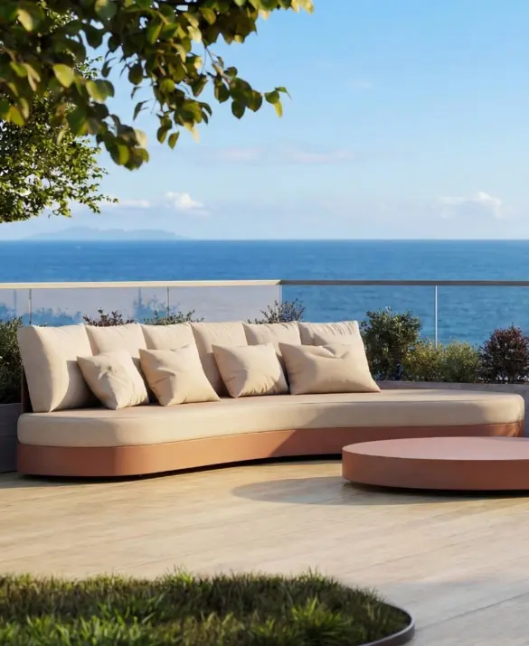HARMONY Sofa by GANSK on a sea-view terrace, a low modular outdoor sofa with plush cushions and a round coffee table.