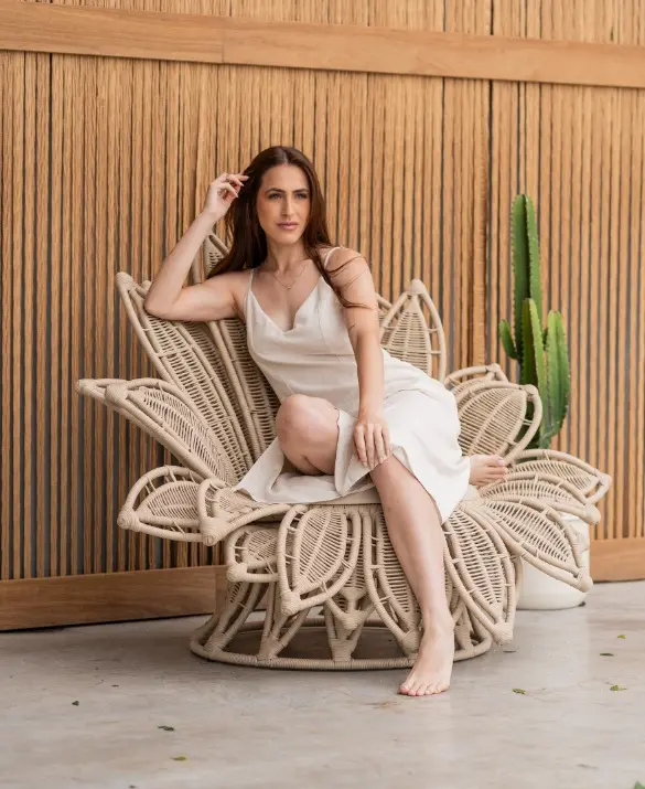 An armchair reminiscent of a flower. Made of off-white nautical rope and upholstered in white on the seat.
