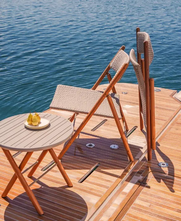 Two folding armchairs leaning against each other. The seat and backrest are woven with gray rope and the frame is made of wood.