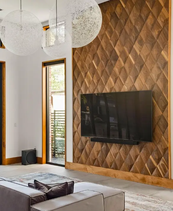 Luxury high-ceiling living room featuring a 3D walnut wood panel TV wall with a diamond pattern and large windows.