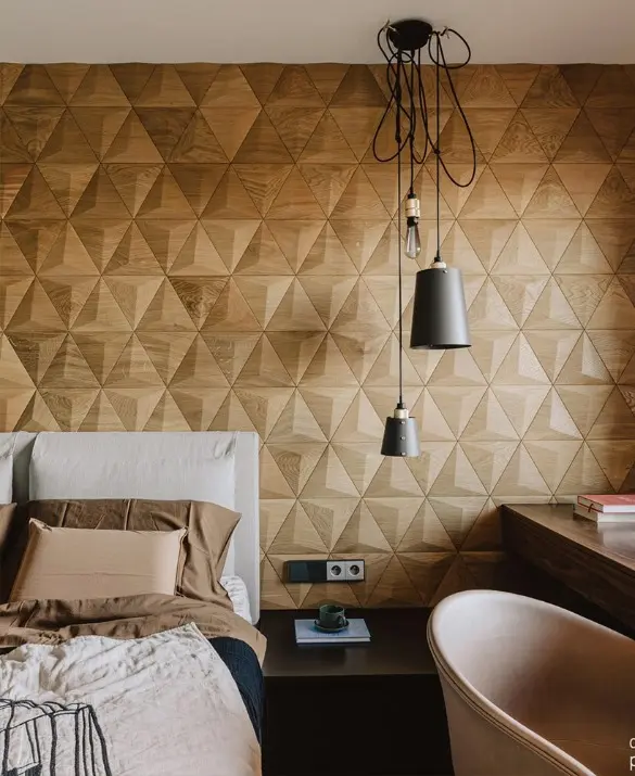 Modern bedroom featuring a 3D oak wood pyramid-shaped accent wall, designer pendant lighting, and a walnut desk.