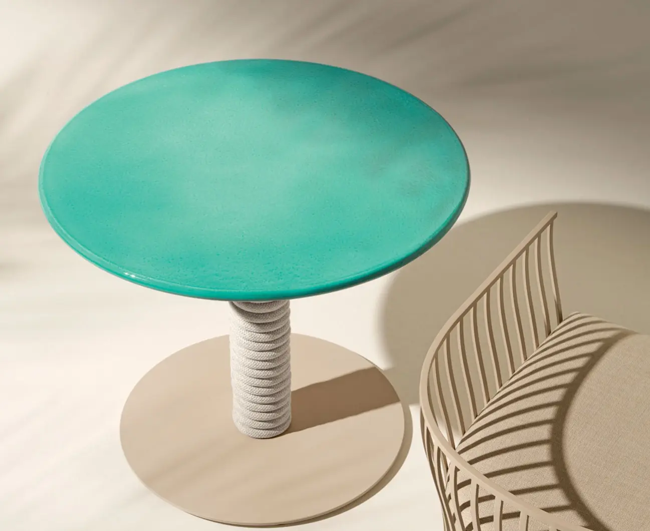 Noon table with aquamarine enamelled top and natural rope base.