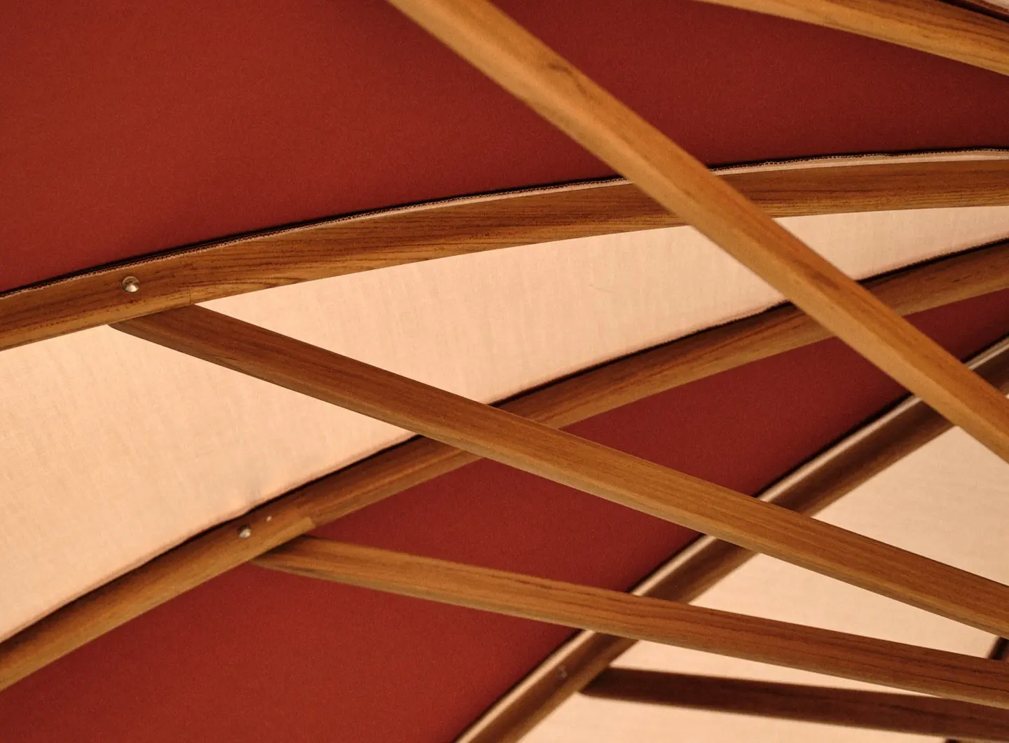 Canopy detail with natural teak ribs and bicolour fabric.