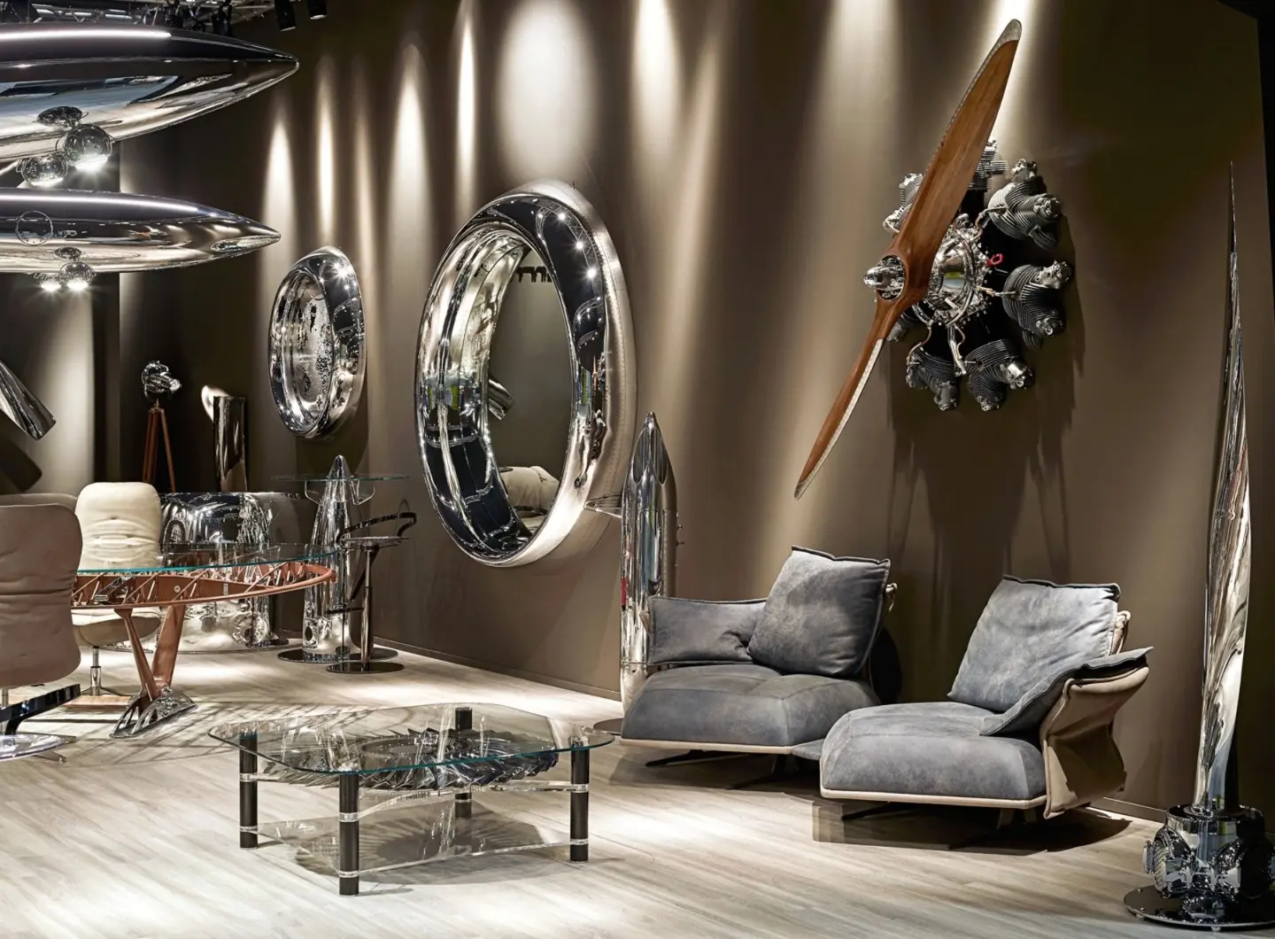 Arteinmotion setting with mirrors, table, decorative elements and propeller engine, luxury Made in Italy furnishings crafted from original aircraft parts.