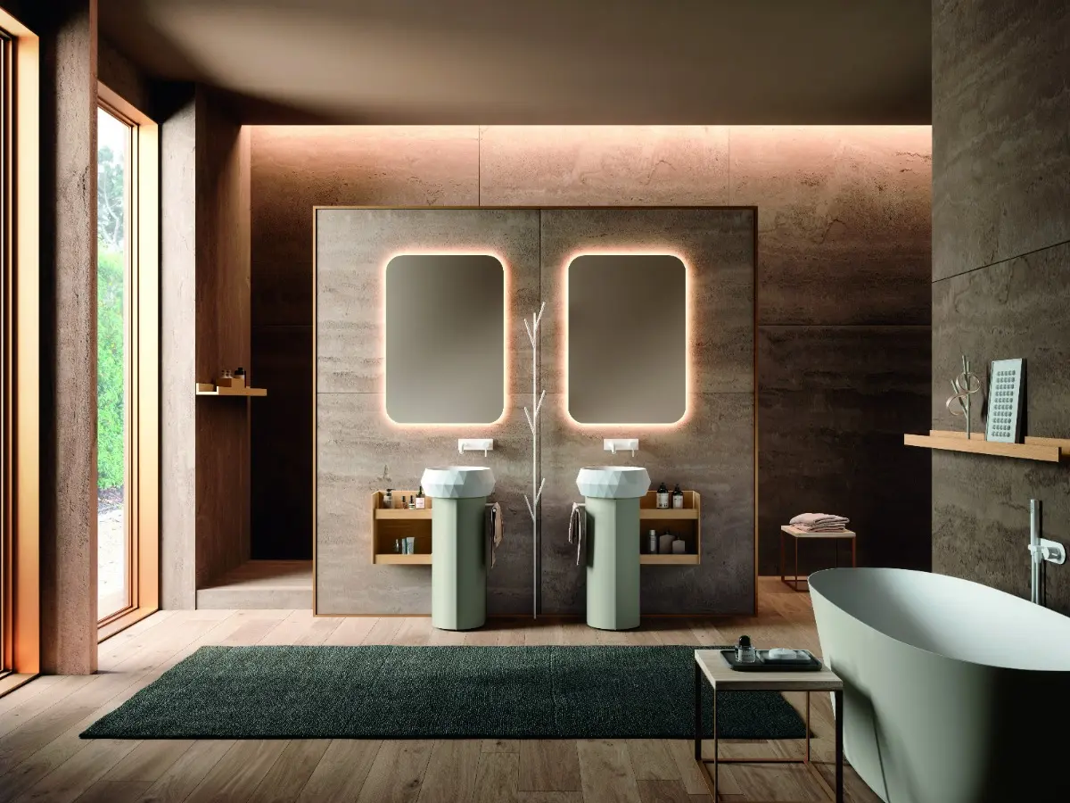 Calix UP. Floor-standing unit with round door in matt peltro lacquer. Open wall unit in Valdweg rovere HPL. Diamond countertop washbasin in white Teknorit. Round mirror with perimeter led lighting. Salus bathtub in solid surface. Tree-shaped towel holder in matt white lacquer.